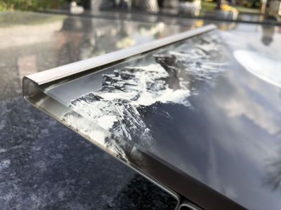 Glass plate with a photo in a stainless steel stand